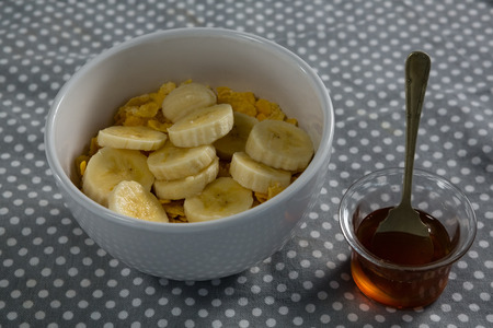 Bowl of corn flakes with banana an honeyの写真素材