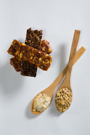 Close-up of cereal bars with cereals in spoon ready for breakfastの写真素材