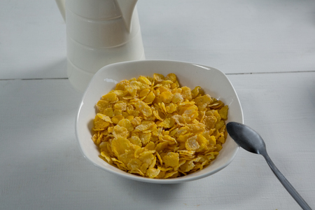 Bowl of wheaties cereal with spoon on white backgroundの写真素材