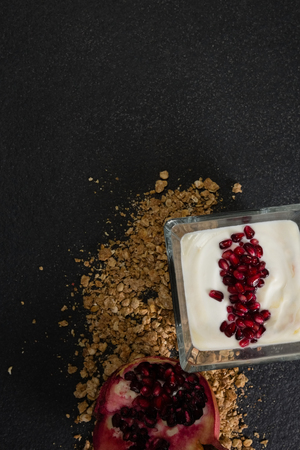 Close-up of yogurt with pomegranate slice and granolaの写真素材