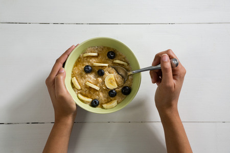 Woman having healthy breakfast on white backgroundの写真素材