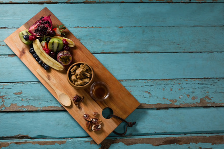 Slice of various fruits in tray on wooden tableの写真素材