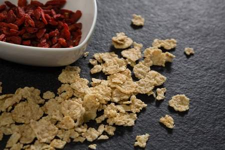 Bowl of dried fruits with corn flakes on table