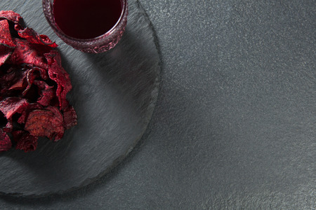 Overhead view of juice with beetroot on plate over slateの写真素材