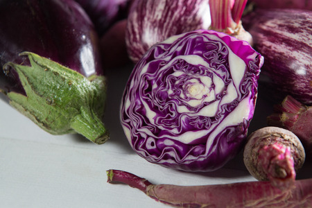 Close-up of eggplants with red cabbage on tableの写真素材