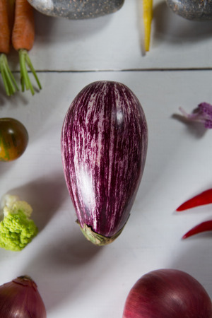 Close-up of eggplant with olive and carrots on tableの写真素材