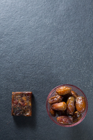 Overhead view of dates fruits in bowl on gray slateの写真素材