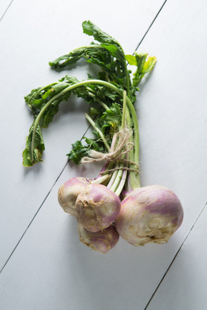 High angle view of turnip bunch on wooden tableの写真素材