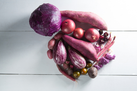 Overhead view of various vegetables on wooden table