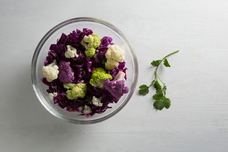 Overhead view of cauliflowers and red cabbages in bowl on tableの写真素材