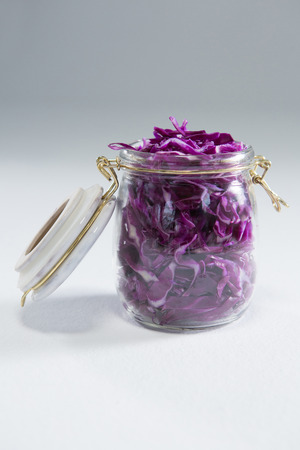 Chopped red cabbage in a jar on white backgroundの写真素材