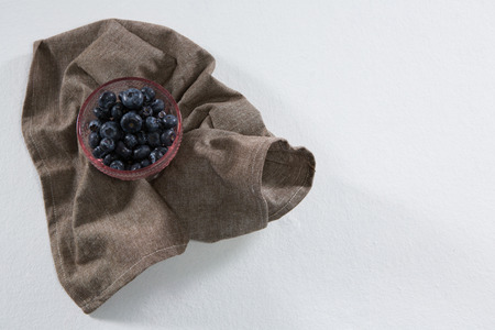Close-up of blueberries in bowl on a textileの写真素材