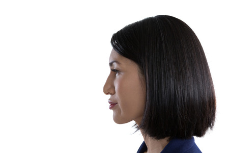 Close-up of thoughtful businesswoman against white backgroundの写真素材