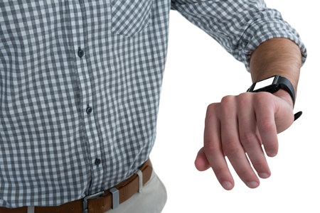 Mid section of man wearing smartwatch against white backgroundの写真素材