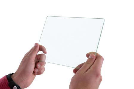 Close-up of man holding glass digital tablet against white backgroundの写真素材