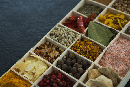 Close-up of various spices arranged in trayの写真素材