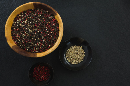 Black pepper in bowl on black backgroundの写真素材