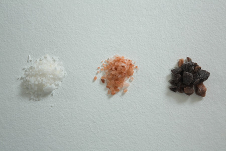 Close-up of various salts on white backgroundの写真素材