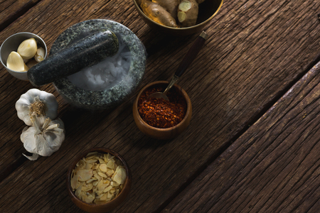 Various type of spices in bowl on wooden tableの写真素材