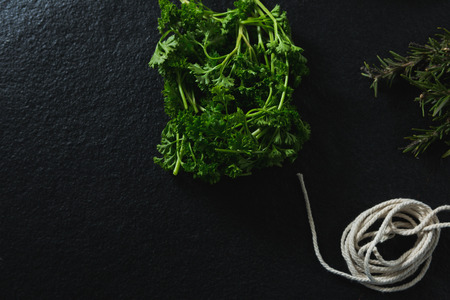 Various type of herbs and rope on black backgroundの写真素材