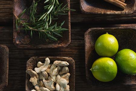 Close-up of dried ginger, lime and rosemary herb in a bowlの写真素材