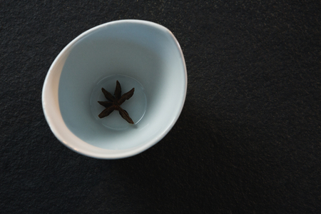Close-up of star anise on a bowl on black backgroundの写真素材