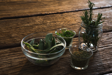Close-up of various herbs in a jar on wooden tableの写真素材
