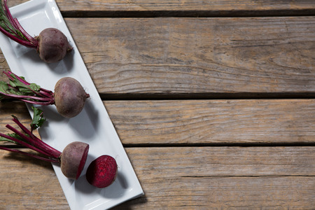 Beetroot arranged in tray on wooden tableの写真素材
