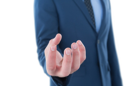 Mid section of businessman marketing invisible product while standing against white backgroundの写真素材