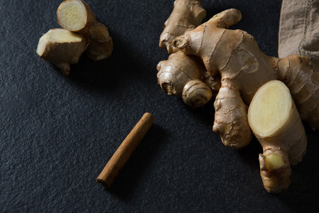 Close-up of ginger and cinnamon on black backgroundの写真素材