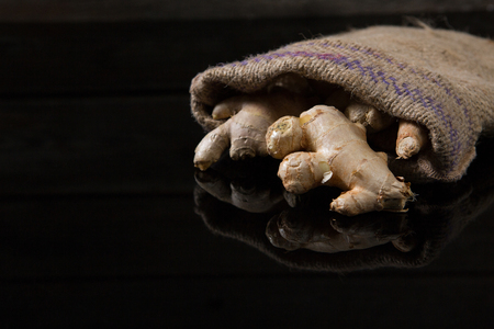 Close-up of ginger in sack on black background