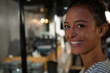 Portrait of happy woman sitting in restaurantの写真素材