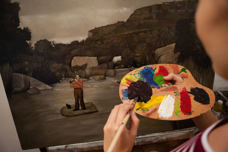 Close-up of woman painting on canvas in drawing classの写真素材