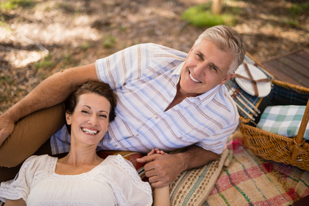 Portrait of happy couple relaxing in cottage during safari vacationの写真素材