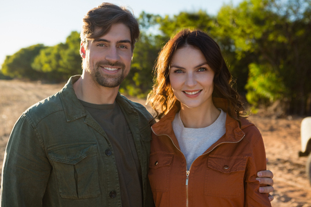 Portrait of young couple standing on fieldの写真素材