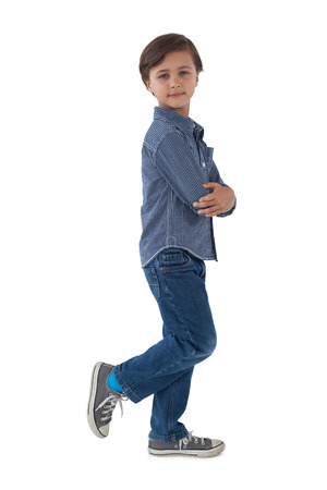 Portrait of boy posing against white backgroundの写真素材