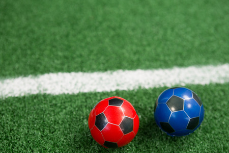 Close-up of footballs on artificial grassの写真素材