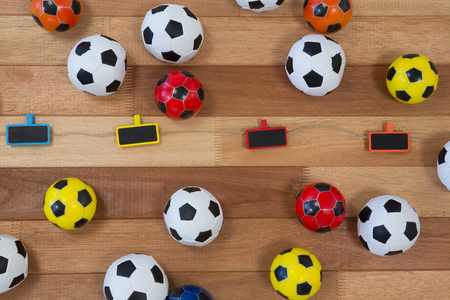 Overhead of colorful footballs on wooden tableの写真素材
