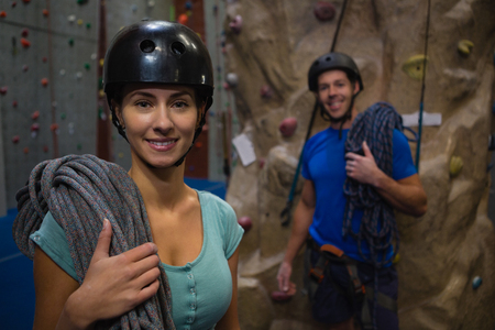 Portrait of athletes in sports helmet carrying ropes while standing at classの写真素材