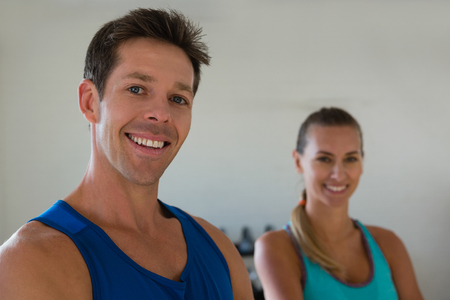 Portrait of smiling confident athletes standing in gymの写真素材