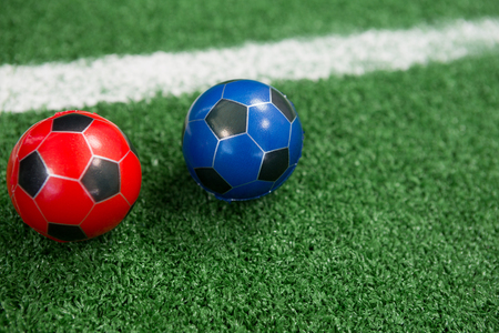 Close-up of footballs on artificial grassの写真素材