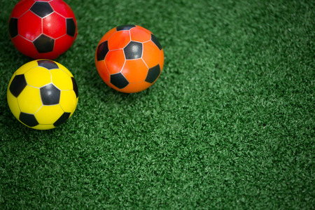Close-up of footballs on artificial grassの写真素材