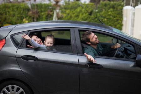 Happy father, mother and daughter in the carの写真素材