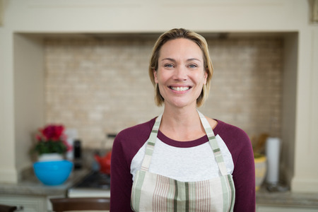 Portrait of woman standing in the kitchenの写真素材
