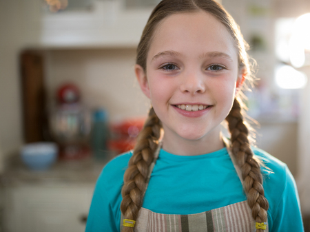 Portrait of young girl smiling at homeの写真素材