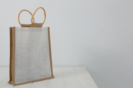 Close-up of bag on table against white wallの写真素材