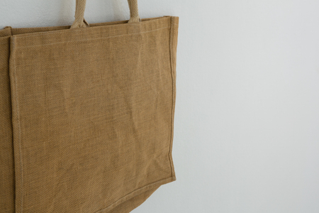 Close-up of bag hanging against white wall