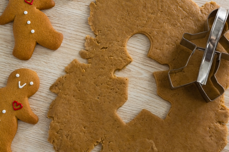 Close-up of gingerbread dough with cookie cutter on wooden tableの写真素材