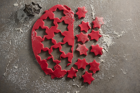 Close-up of star shape cookies with flour and cutterの写真素材