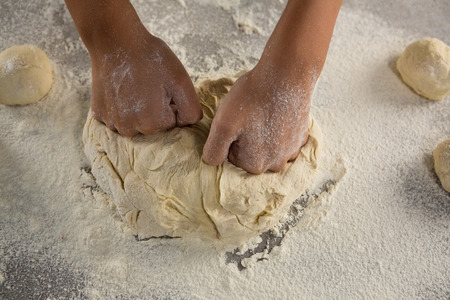 Close-up of woman kneading a doughの写真素材
